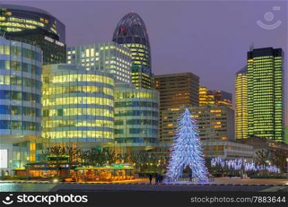 Paris, France - December 19, 2014: Christmas tree among the skyscrapers of La Defense. Defense - Parisian Manhattan, the largest business center in Europe.