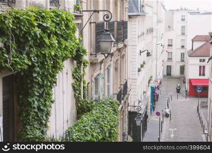 Paris, France - May 22, 2012: Houses on Montmartre street in Paris,in the spring day view from a height.. Paris, France - May 22, 2012: View from the heights, to the street and houses of the city on a spring afternoon