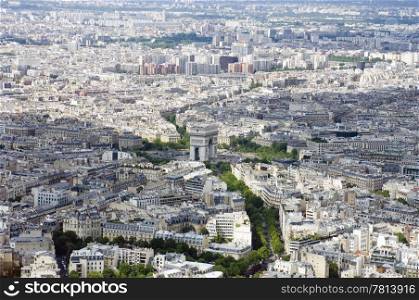 Paris from above, seen from the Eiffel Tour. In the center is the Arc de Triomphe as figurative centerpoint between two patches of clouds. The lush, tree-lined avenues, including the Champs Elisee are clearly visible
