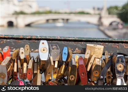 PARIS - JULY 27: Lockers at Pont des Arts symbolize love for ever, July 27, 2013 in Paris. 16000 lockers of loving couples are on that bridge, also known as Passarelle des Arts