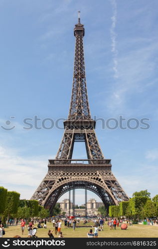 PARIS - JULY 27: Tourists at the Eiffel Tower on July 27, 2013, in Paris. The Eiffel Tower is the most visited tourist attraction in France and one of the most recognizable landmarks in the world.