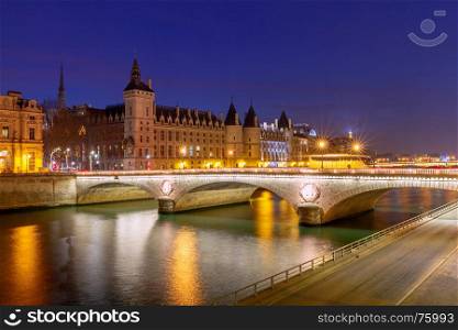 Paris. Quay in the night light.. Embankment along the Conciergerie and the river Seine at night. Paris. France.