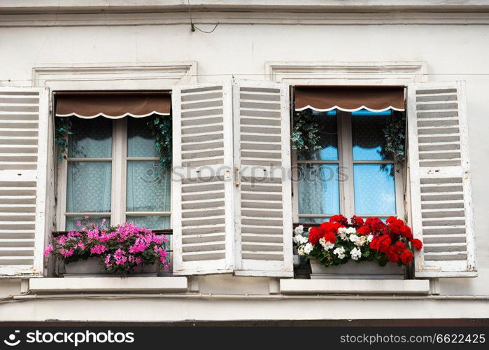 Paris windows with flowers on Montmartre street