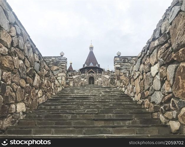 Park Loga, Russia - June 2021: Stone staircase leading to the temple