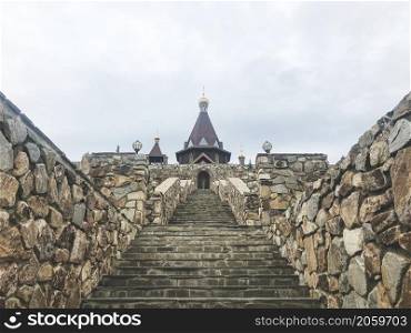 Park Loga, Russia - June 2021: Stone staircase leading to the temple