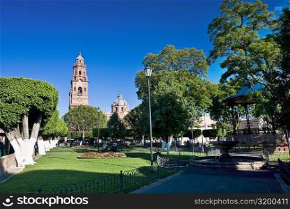Park with a cathedral in the background, Morelia Cathedral, Plaza De Los Martires, Morelia, Michoacan State, Mexico