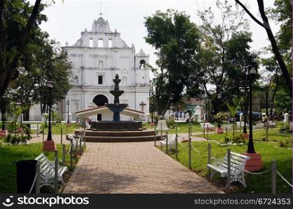 Park with fountain and church in Chaichuapa in Salvador