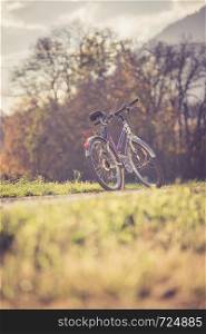 Parked bicycle on a field, autumn time