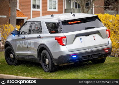 Parked police car with emergency lights illuminated from back. Parked police car with emergency lights illuminated