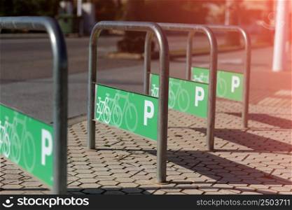 parking for bicycles and skateboards based on a tubular structure of stainless steel bars. selective focus. High quality photo.. parking for bicycles and skateboards based on a tubular structure of stainless steel bars. selective focus. High quality photo