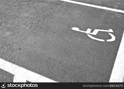 Parking for disabled people in Tel Aviv. Asphalt painted parking lot sign for people with wheelchair in Israel. Black and white picture