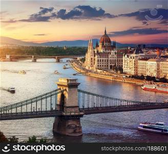 Parliament and famous bridges of Budapest at sunset, Hungary
