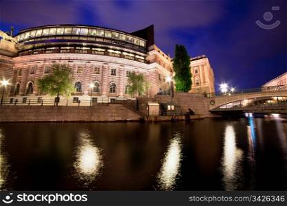 Parliament building in Stockholm, Sweden at night with water reflection
