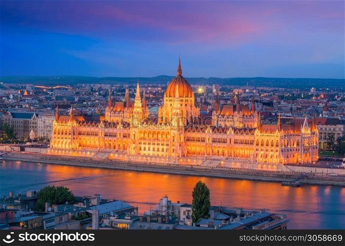 Parliament building over delta of Danube river in Budapest, Hungary at sunset