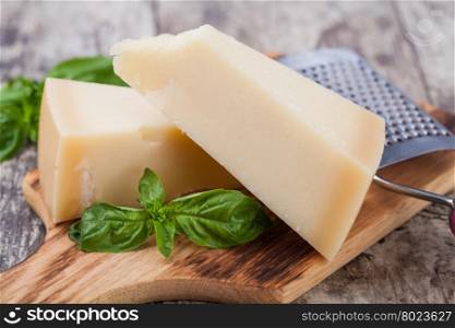parmesan cheese. parmesan cheese on wooden background
