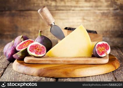 parmesan cheese with fresh figs on wooden background