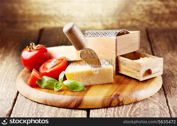 parmesan cheese with grater on wooden background