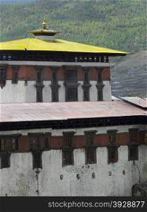Paro Dzong Buddhist monastery in the Kingdom of Bhutan. View from within the covered bridge over the river.