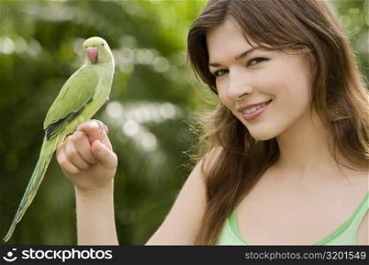 Parrot on a young woman&acute;s hand