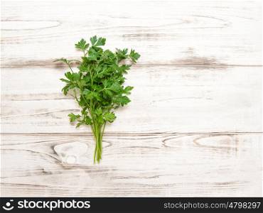 Parsley on wooden background. Fresh organic herbs. Healthy food ingredients