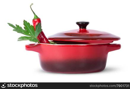 Parsley with red chili pepper in saucepan isolated on white background