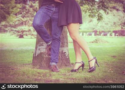 Part body of couple in park. Love and date. Part body of couple lovers dating in summer park outdoor. Filtered photo.