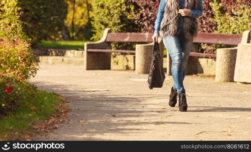 Part body of fashionable woman. Autumnal fashion of women. Fashionable girl wearing trendy clothes walking in park. Part body of model outdoors.