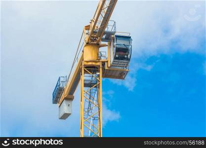 Part of a construction crane against blue sky photographed, space for labeling.