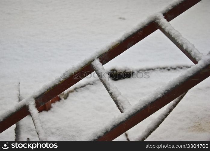 part of a ladder covered in snow