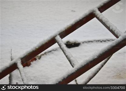 part of a ladder covered in snow