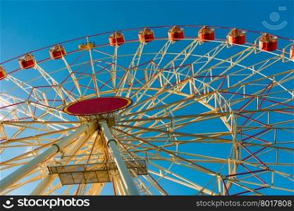 part of a large Ferris wheel on a background of blue sky