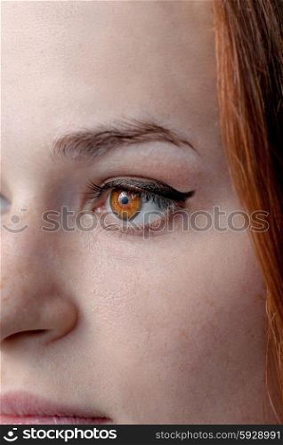 Part of a red haired female face.