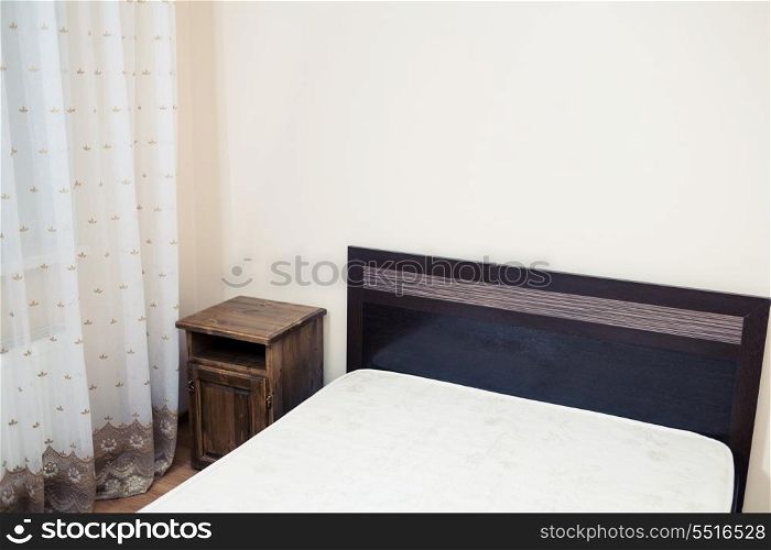 Part of a room with bed in a corner