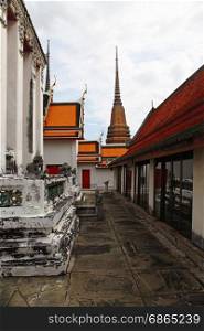 part of Beautiful Wat Phra Kaeo temple with orange and red roof in Thailand