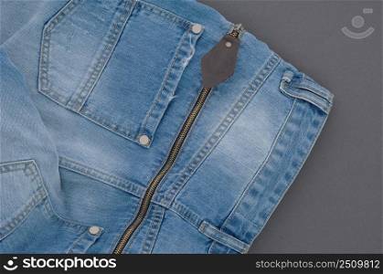 part of denim pants with back pocket and zipper, close-up. jeans close up