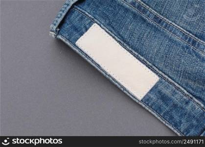 part of denim pants with back pockets and label, close-up. jeans close up
