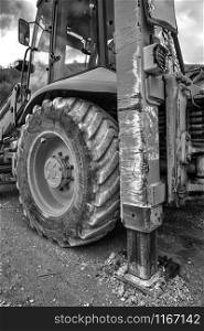 Part of excavator machines in black and white. Vertical view