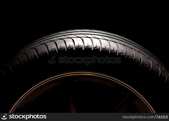 Part of high performance summer car tire on black background