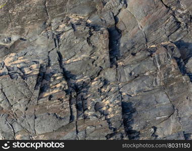 Part of rock close up and sand on stone. Nature background.