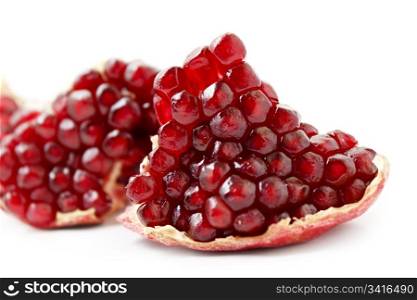 part of tasty pomegranate fruit on white background