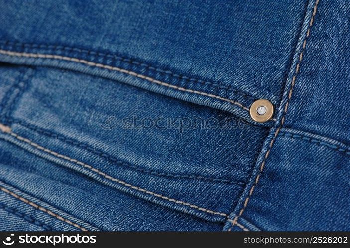 part of the blue denim pants with pockets and rivets, close-up. jeans close up