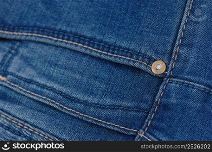 part of the blue denim pants with pockets and rivets, close-up. jeans close up