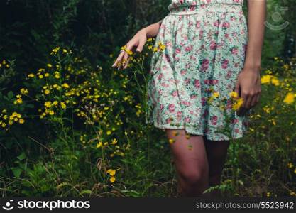 Part of the body. Beautiful woman walks at the country. Casual dress,