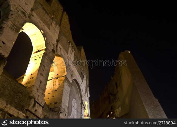 part of the famous coliseum in Rome at night