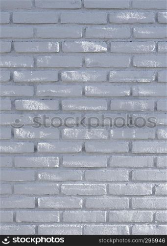 part of white gray brick wall with spots of sunlight