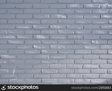 part of white gray brick wall with spots of sunlight