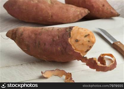 Partially peeled fresh sweet potato