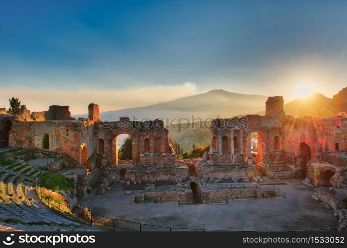 Particular of Ancient theatre of Taormina Sicily Italy with Etna erupting volcano at sunse