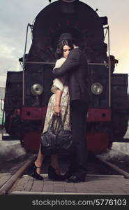 parting of lovely couple on railway station at locomotive background