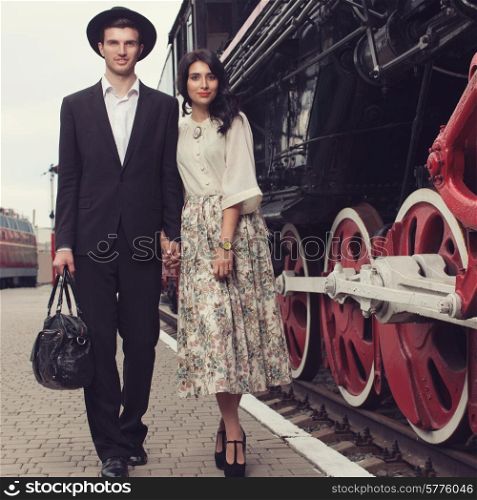 parting of stylish couple of traveler on railway station